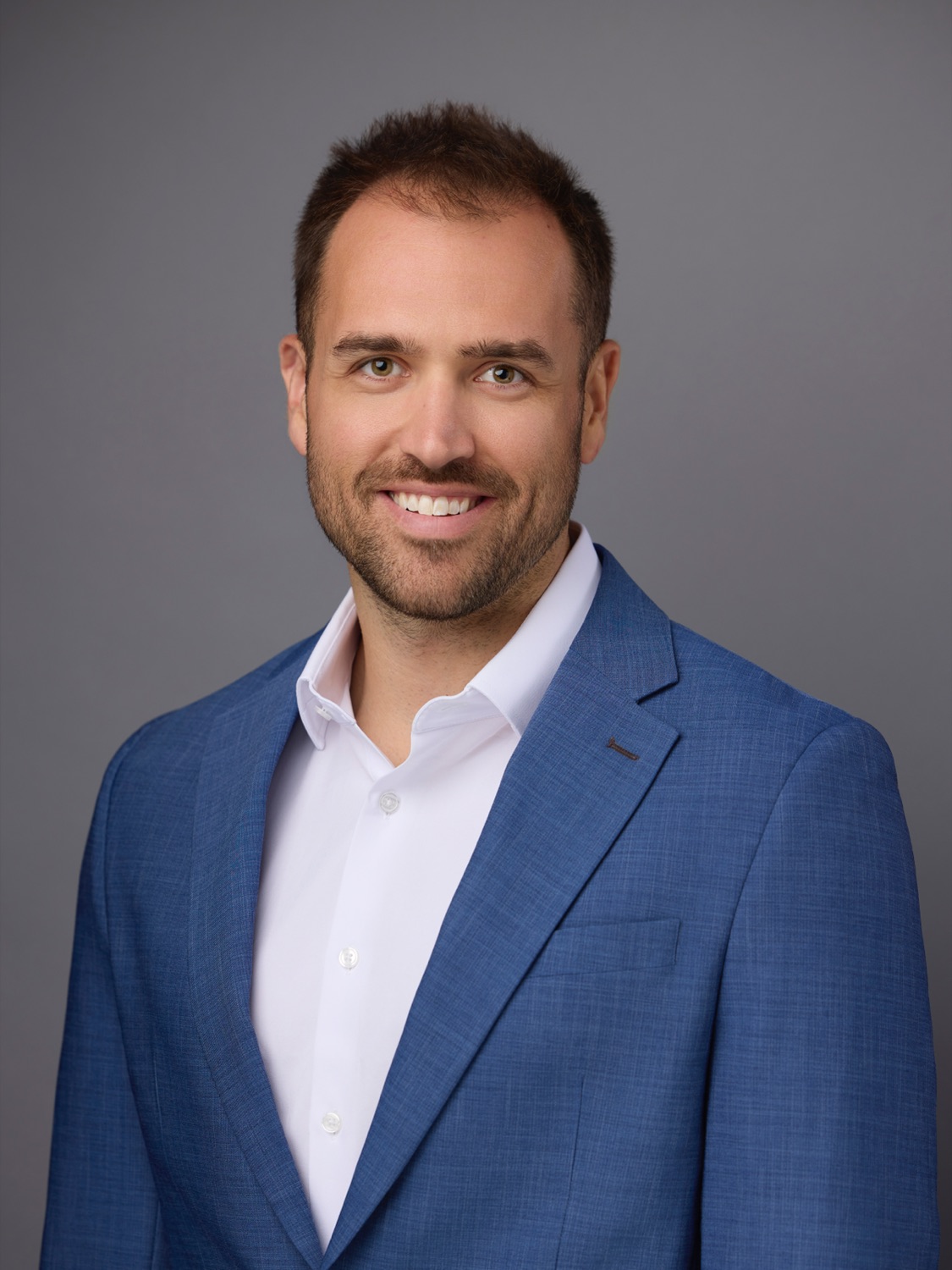 Nick Fischer headshot in a blue blazer
